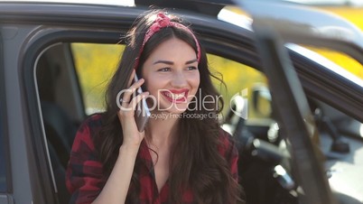 Stylish hipster woman talking on phone in the car