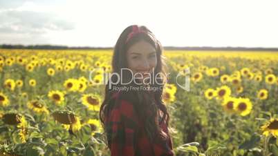 Playful girl relaxing in sunflower field