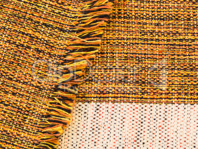 Cotton fabric blended of orange, black, yellow and white, folded with fringes