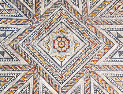Ancient roman stone mosaic floor with geometric design