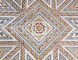 Ancient roman stone mosaic floor with geometric design