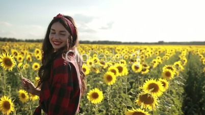 Joyful girl with sunflower enjoying nature