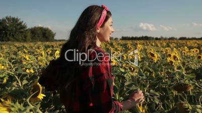 Happy summer girl laughing in sunflower field