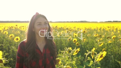 Delighted girl enjoying summer in sunflower field