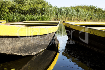 Row boat floating on the lake and reflects in it