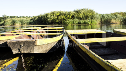 Row boat floating on the lake and reflects in it