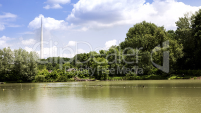 Landscape of bridge, pond and clouds