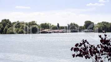 Boats  and rafts anchored on Danube river with beautiful blue sk