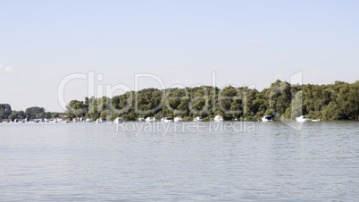 Boats anchored on Danube river with beautiful blue sky