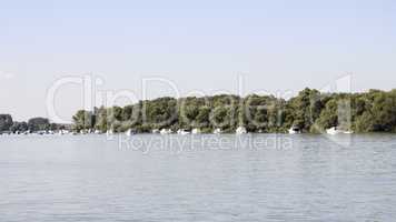 Boats anchored on Danube river with beautiful blue sky