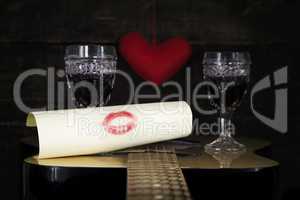 Kiss On White Paper Resting on Acoustic Guitar With Vine Glasses