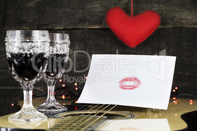Happy Valentine's Day Kiss On White Paper Resting on Acoustic Gu