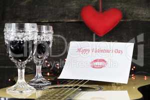 Happy Valentine's Day Kiss On White Paper Resting on Acoustic Gu