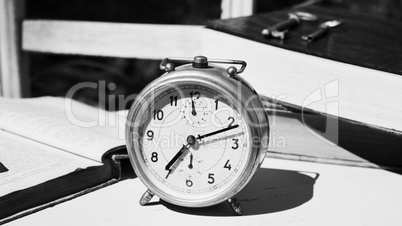 Vintage still life with old alarm clock, keys and books