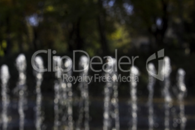 Fountain Splashing Water In The Park Blured For Background Use