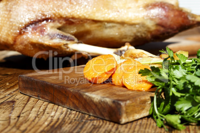 Roasted goose on wooden table