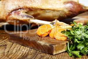 Roasted goose on wooden table