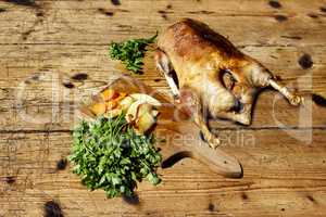 Roasted goose on wooden table