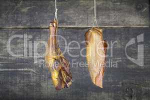 Smoked Chicken Meat Hanging on the Rope Against Wooden Backgroun