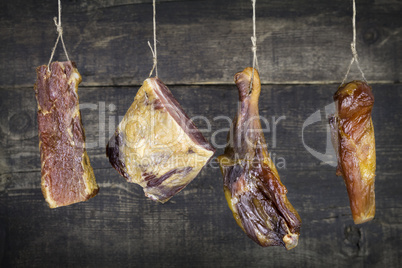 Smoked Meat Hanging on the Rope Against Wooden Background