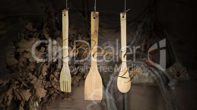 Kitchen Utensils Hanging On A Rope Against Rustic Wooden Backgro