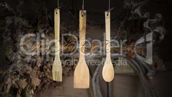 Kitchen Utensils Hanging On A Rope Against Rustic Wooden Backgro