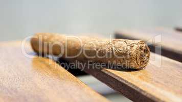 Cuban cigar resting on a wooden surface
