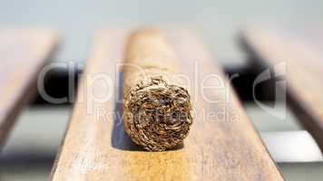 Cuban cigar resting on a wooden surface