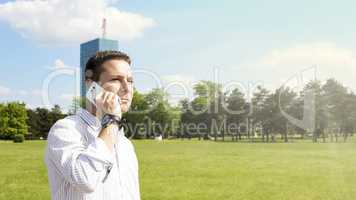 Successful Businessman Talking On The Phone In The Park With Cor
