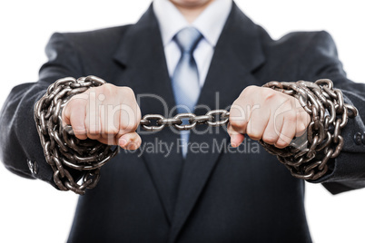 Businessman struggles metal chain tied hands