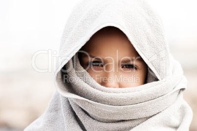 Little child boy wearing arabian burka style clothing