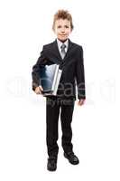 Smiling child boy in business suit holding books