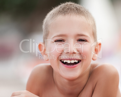 Handsome smiling child boy taking sunbath