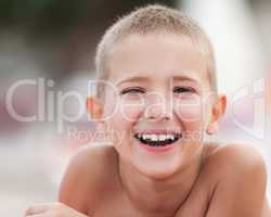 Handsome smiling child boy taking sunbath
