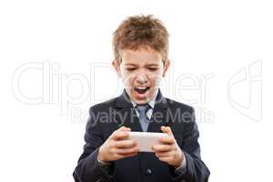 Smiling child boy in business suit playing games or surfing inte