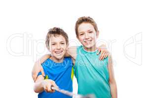 Two smiling child boy brothers holding mobile phone or smartphon