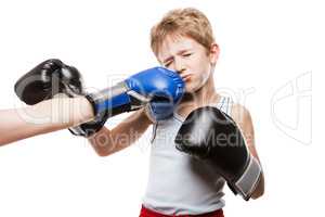Handsome boxer child boy training boxing sport got punched