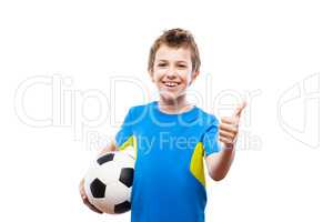 Handsome smiling child boy holding soccer ball gesturing thumb u