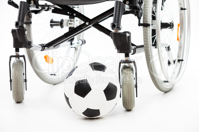 Wheelchair for invalid or disabled person and soccer ball
