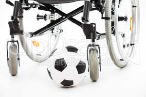 Wheelchair for invalid or disabled person and soccer ball