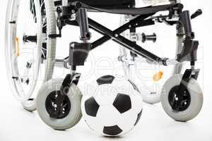 Wheelchair for invalid or disabled person and soccer ball