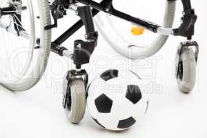 Wheelchair for invalid or disabled person and soccer ball