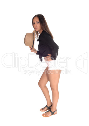 Woman in shorts, holding a cowboy hat