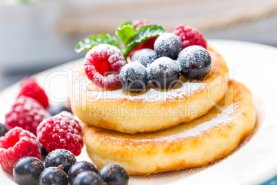 Cottage cheese pancakes, syrniki, curd fritters with berries