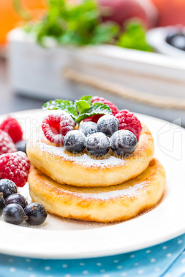 Cottage cheese pancakes, syrniki, curd fritters with berries