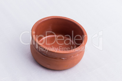 A brown bowl made out of clay