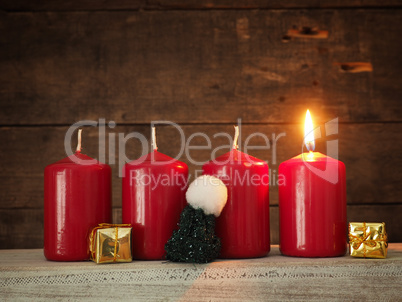 Red Advent candles on a wooden background