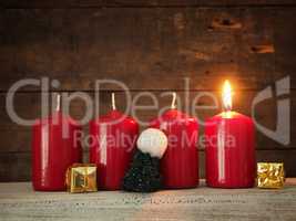 Red Advent candles on a wooden background