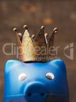 Blue piggy bank with a crown