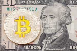 Golden cruptocurrency yellow 'bitcoin on ten dollar banknote bac
